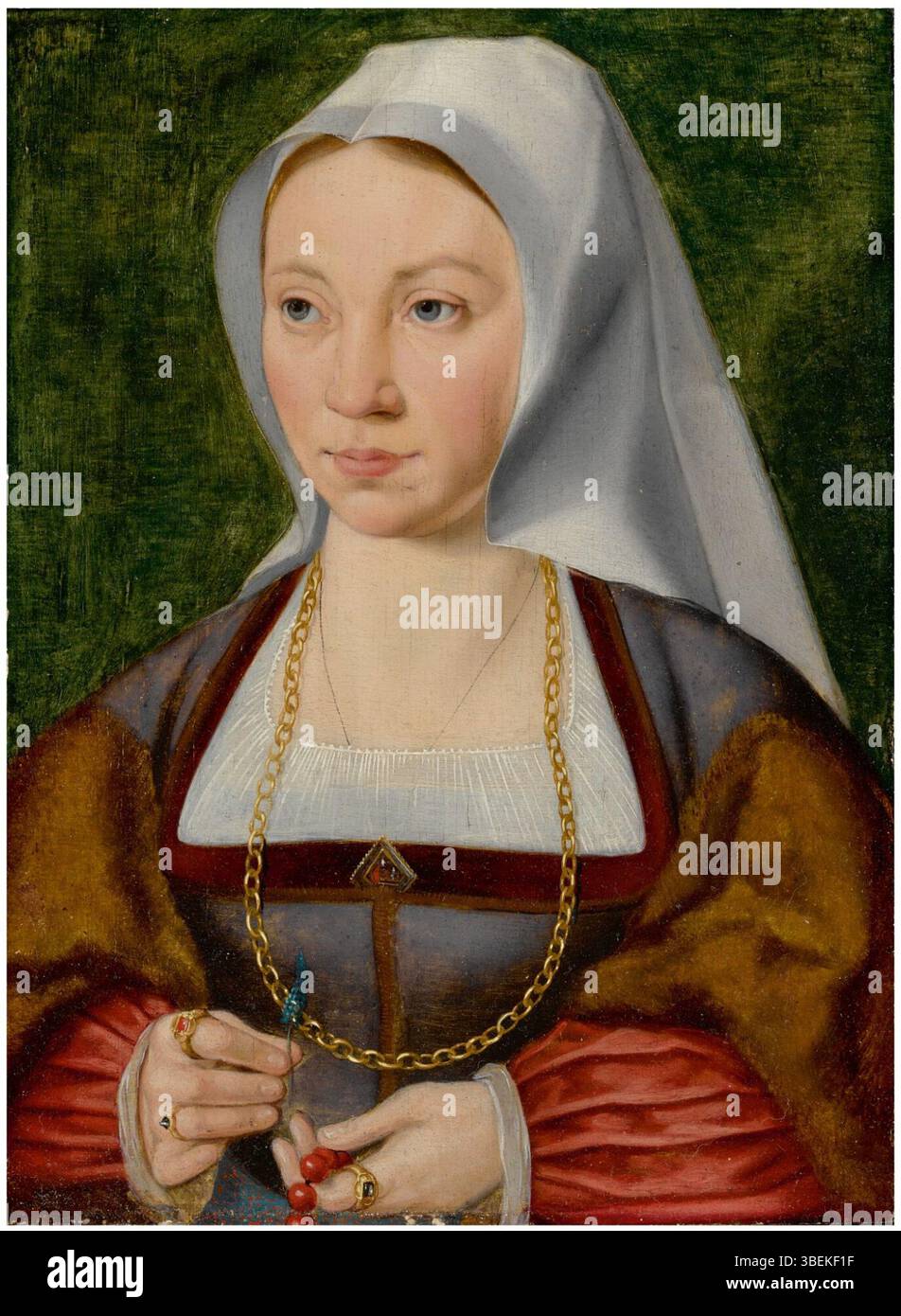 Ce portrait, attribué à Joos van Cleve, représente une dame tenant un chapelet et une fleur. Le tableau est un bel exemple de portrait de la Renaissance du Nord, créé vers 1500. Banque D'Images
