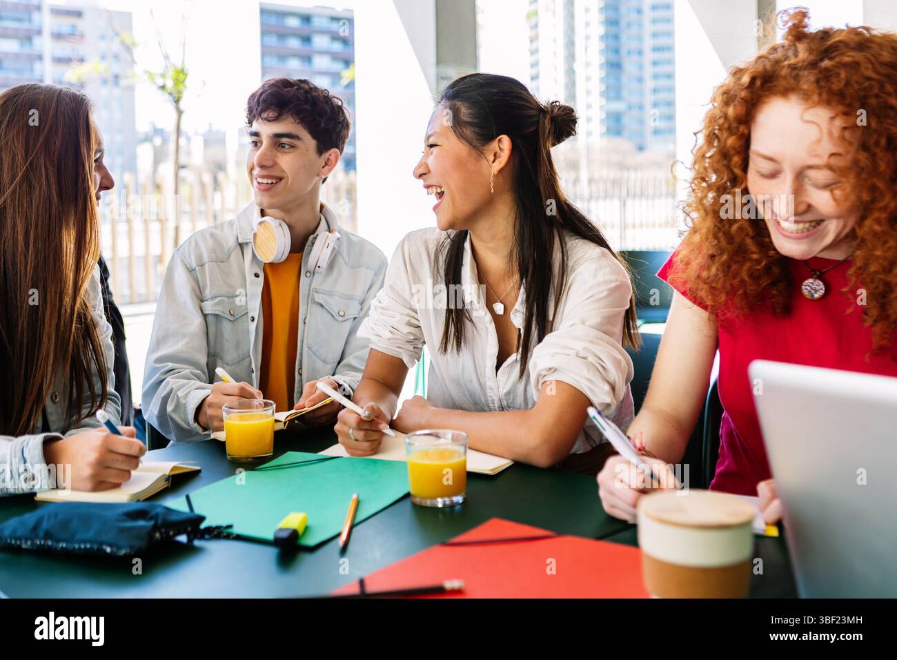 Groupe diversifié d'étudiants universitaires étudiant ensemble à la cafétéria de l'université. Banque D'Images