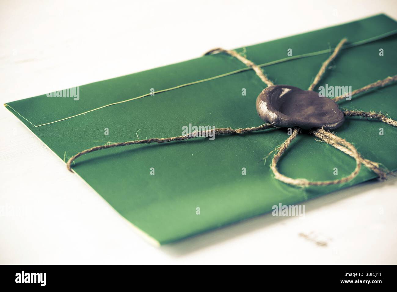 Lettre verte enveloppe avec cachet de cire sur la surface en bois Banque D'Images