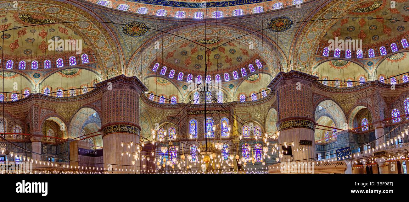 Intérieur de la Mosquée bleue, Istanbul, Turquie. L'intérieur de la Mosquée bleue (Mosquée du Sultan Ahmed) à Istanbul est réputé pour ses caractéristiques architecturales étonnantes. Construit au début du XVIIe siècle, il est célèbre pour son vaste dôme, entouré de petits dômes et semi-dômes, créant un sentiment de grandeur. L'intérieur de la mosquée est orné de plus de 20 000 carreaux de céramique faits à la main en bleu et blanc, ainsi que de calligraphies complexes et de vitraux. Il sert à la fois de lieu de culte et d'attraction touristique majeure, reflétant la grandeur de l'architecture ottomane. Banque D'Images
