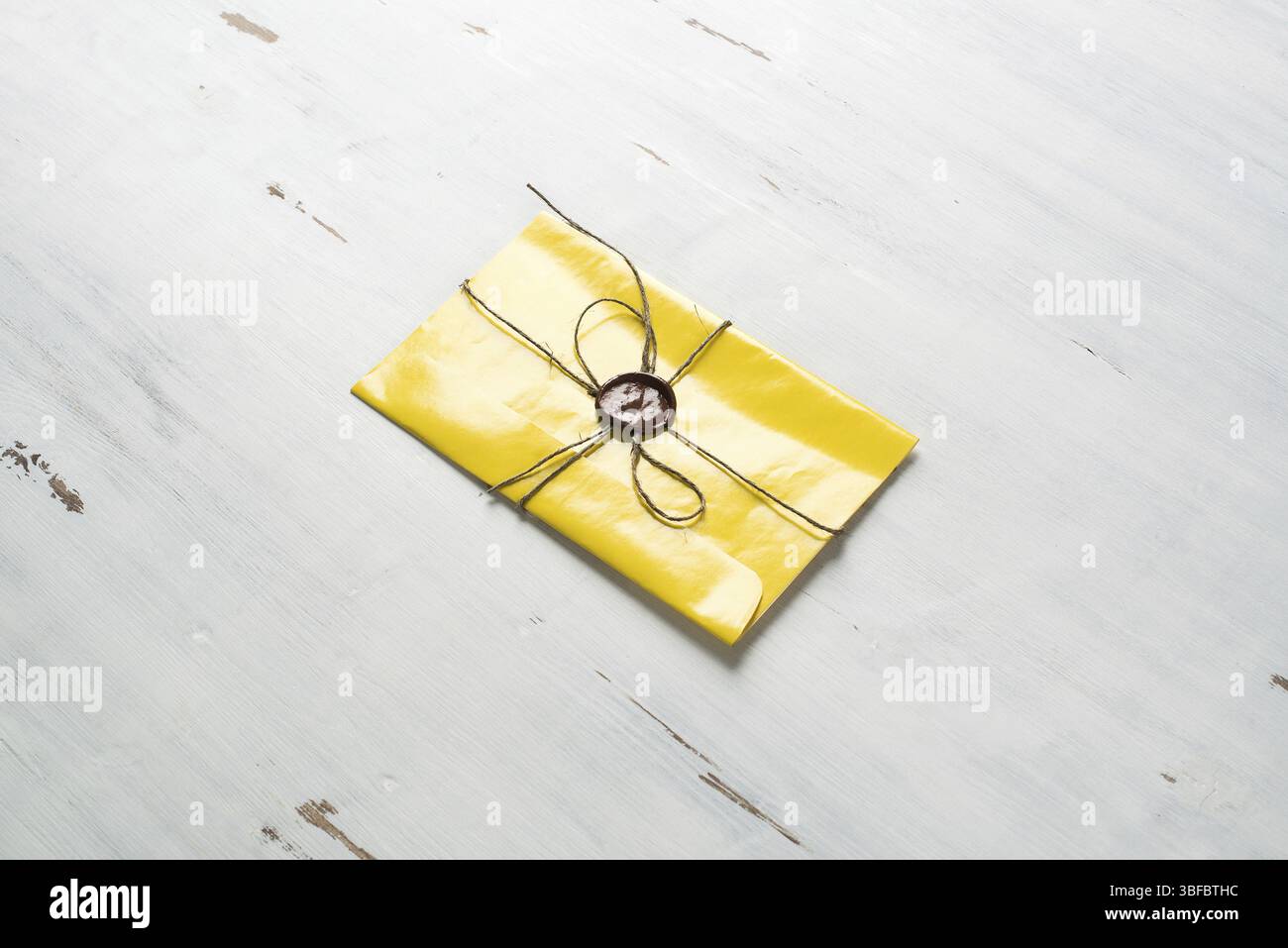 Lettre jaune enveloppe avec cachet de cire sur la surface en bois Banque D'Images