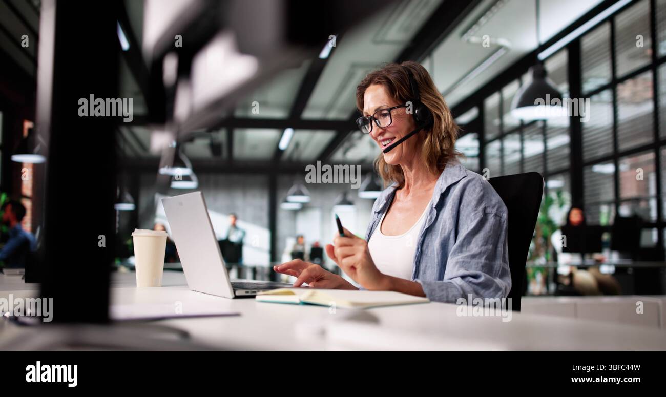 Smiling Call Center Representative offre un service clientèle exceptionnel par téléphone. Banque D'Images