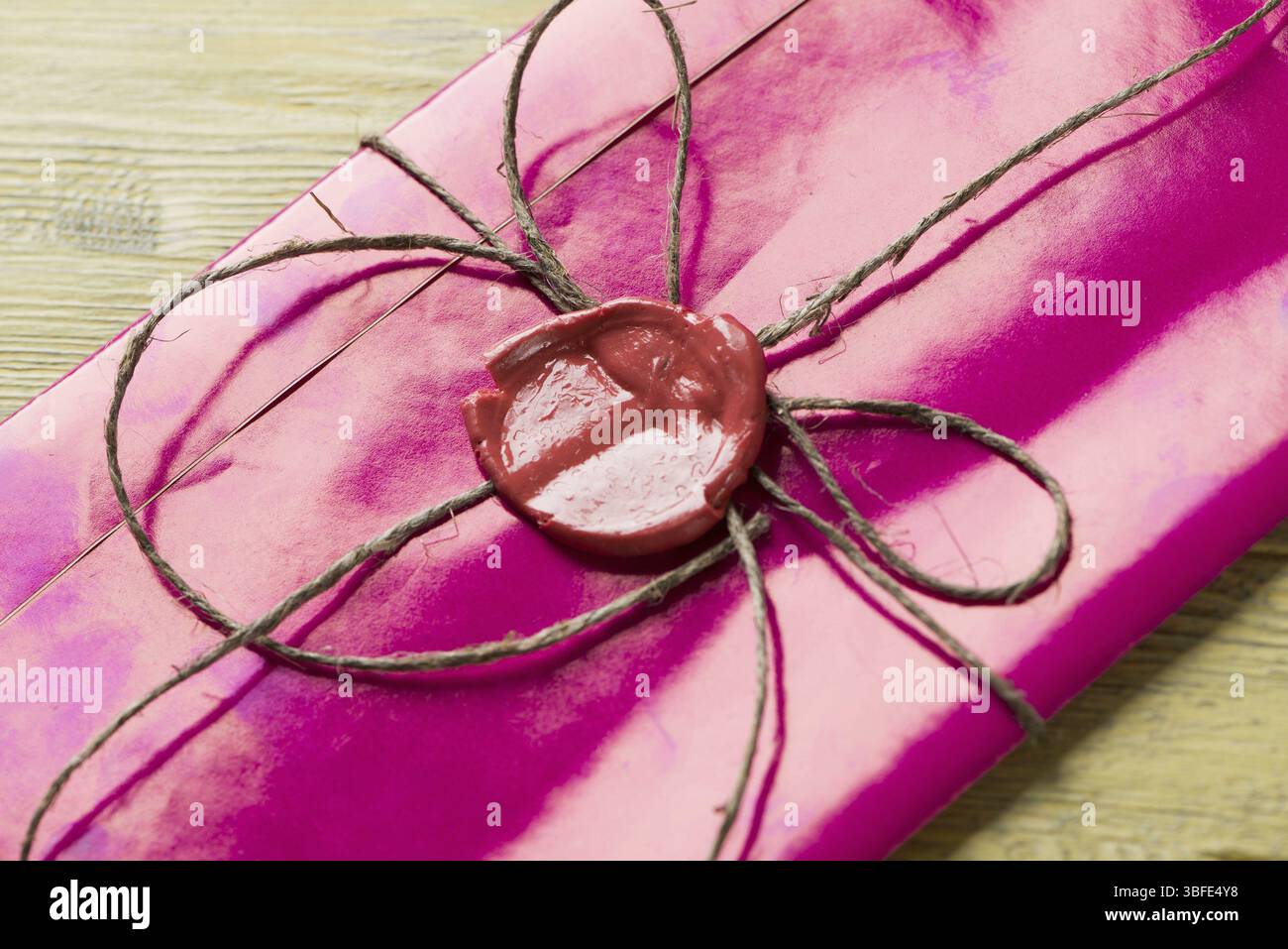 Lettre rose enveloppe avec cachet de cire sur la surface en bois Banque D'Images