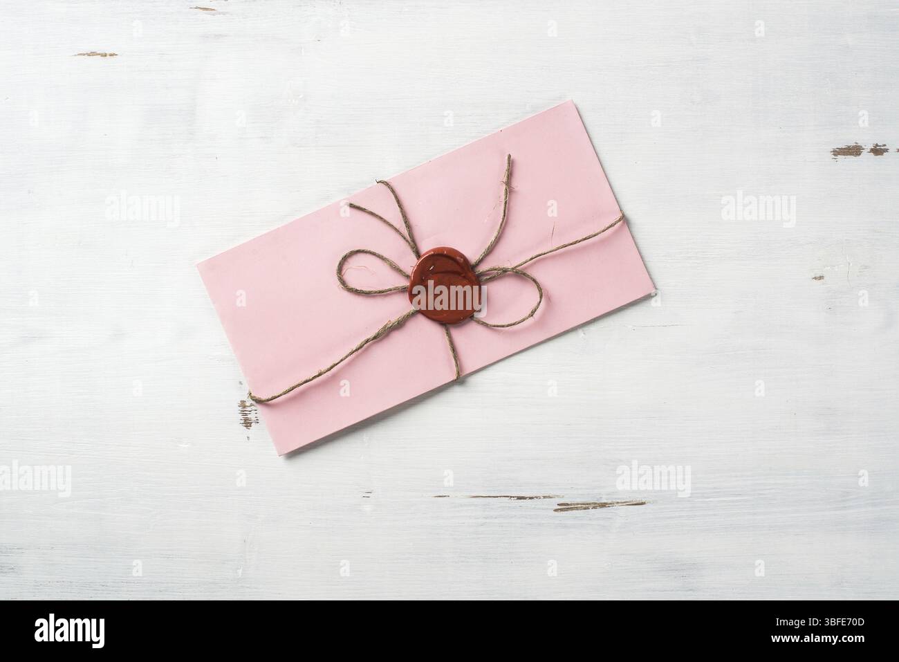 Lettre rose enveloppe avec cachet de cire sur la surface en bois Banque D'Images