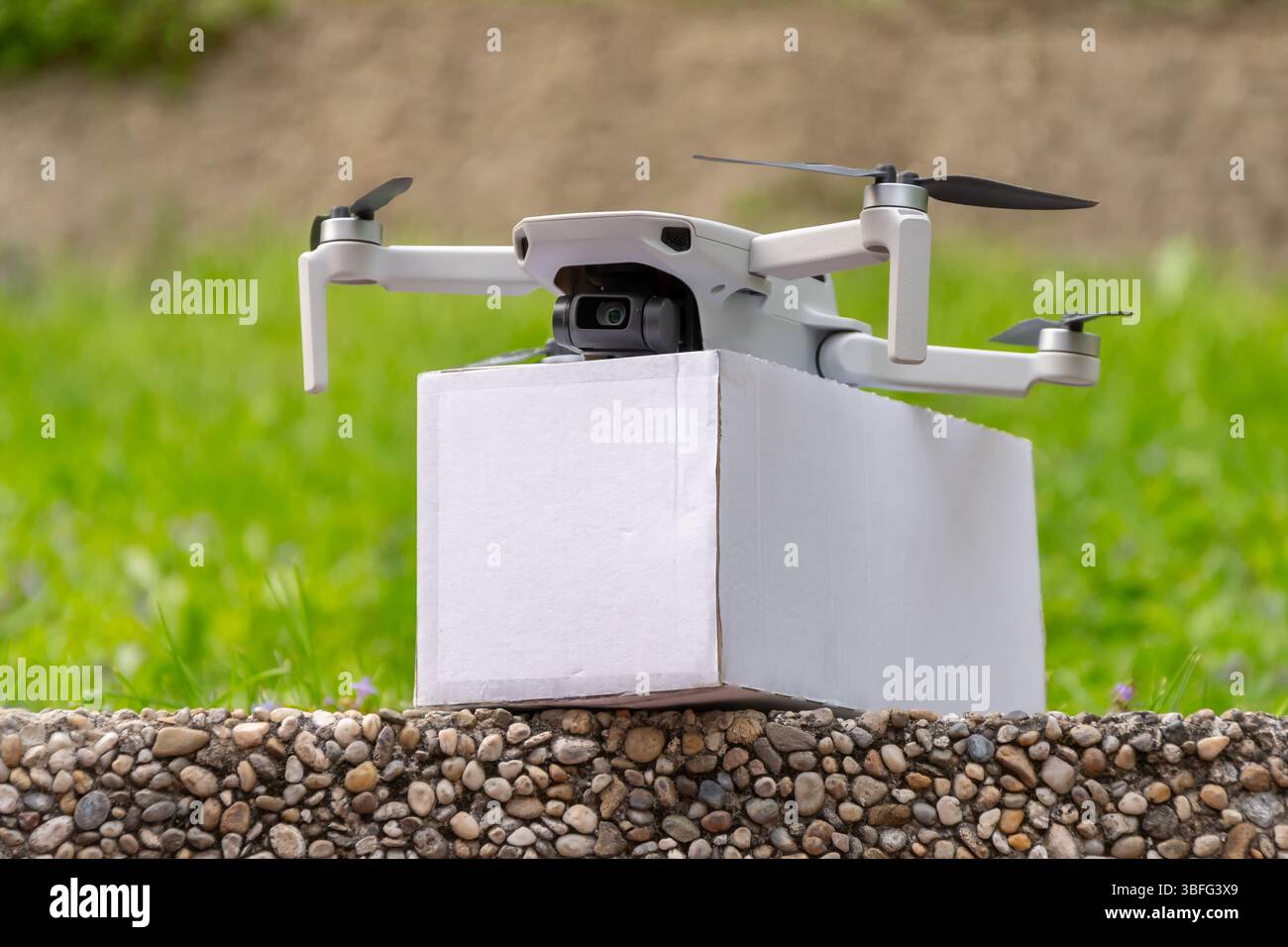 Livraison par drone - un drone avec un colis blanc sur fond de nature. Un symbole de livraison écologique et rapide Banque D'Images