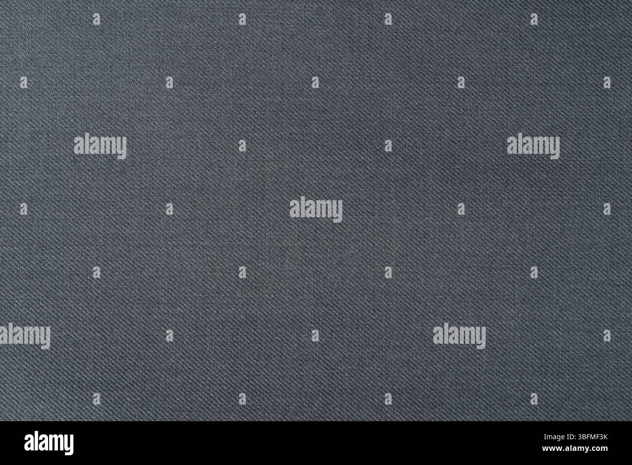 Vue détaillée du tissu gris foncé avec une texture subtile qui peut améliorer les conceptions et les textiles pour diverses applications. Banque D'Images