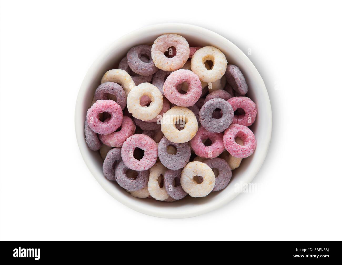 Bol vue de dessus avec divers cercles de fruits et vitamines céréales de petit déjeuner sur blanc. Banque D'Images