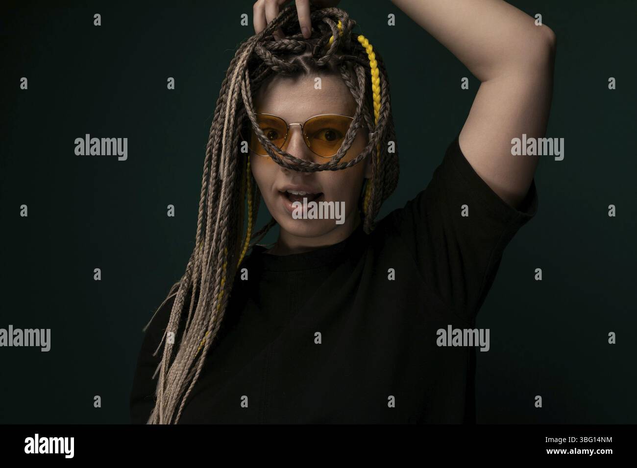 Une femme avec des dreadlocks stylisés sur sa tête est montrée dans la photographie. Les cheveux pour femmes sont soigneusement tordus et longs, créant un aspect visuel saisissant Banque D'Images