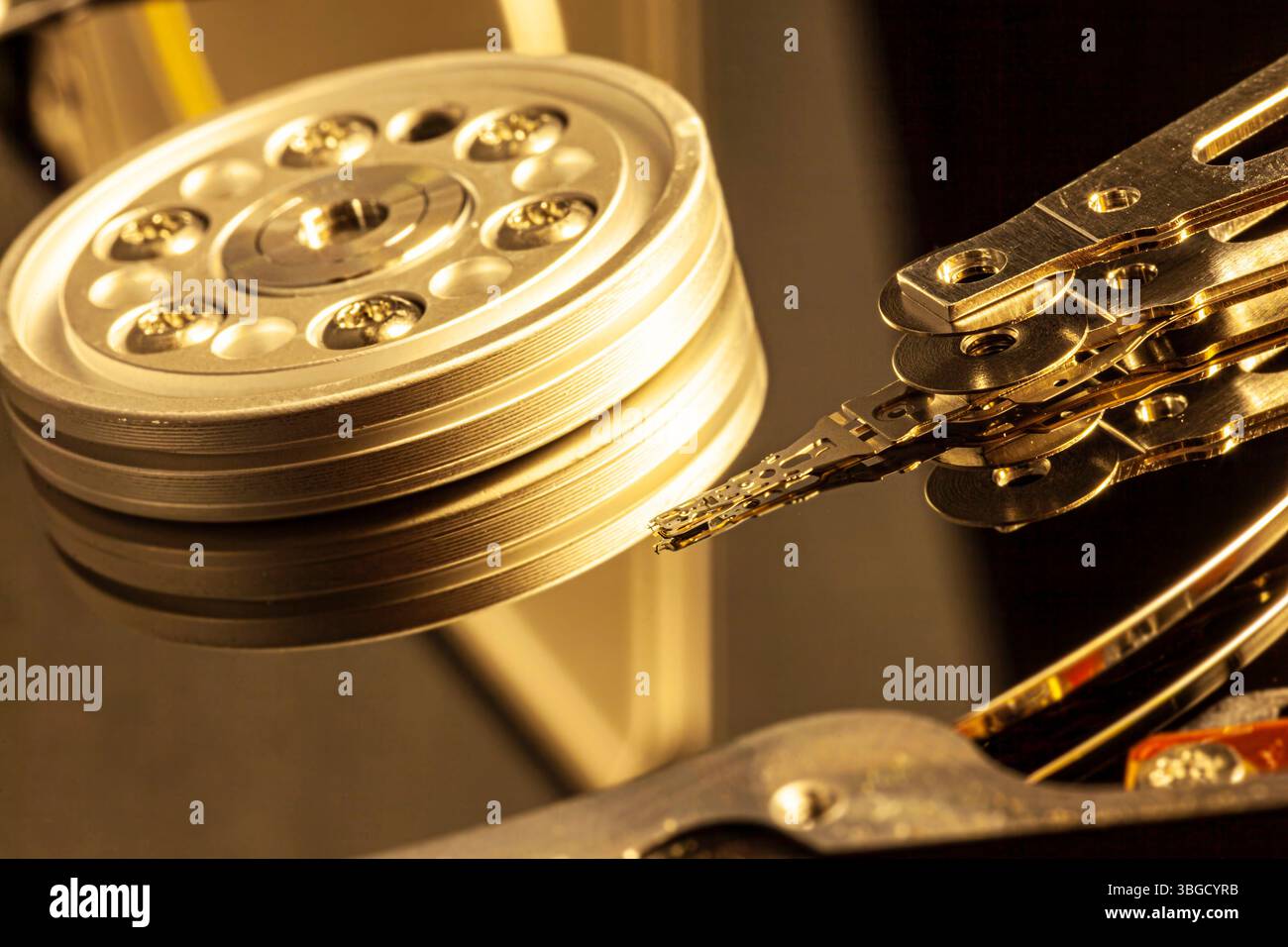 Gros plan d'un disque dur ouvert lisant des données, avec bras d'actionneur et plateaux Banque D'Images