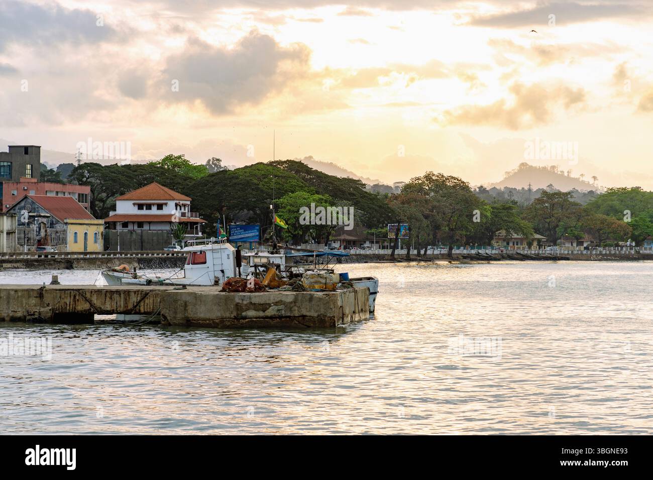 Jetée portuaire et bateau de pêche sous un ciel nocturne dramatique à Ana Chavez Bay à Sao Tomé sur l'île de Sao Tomé en Afrique de l'Ouest Banque D'Images