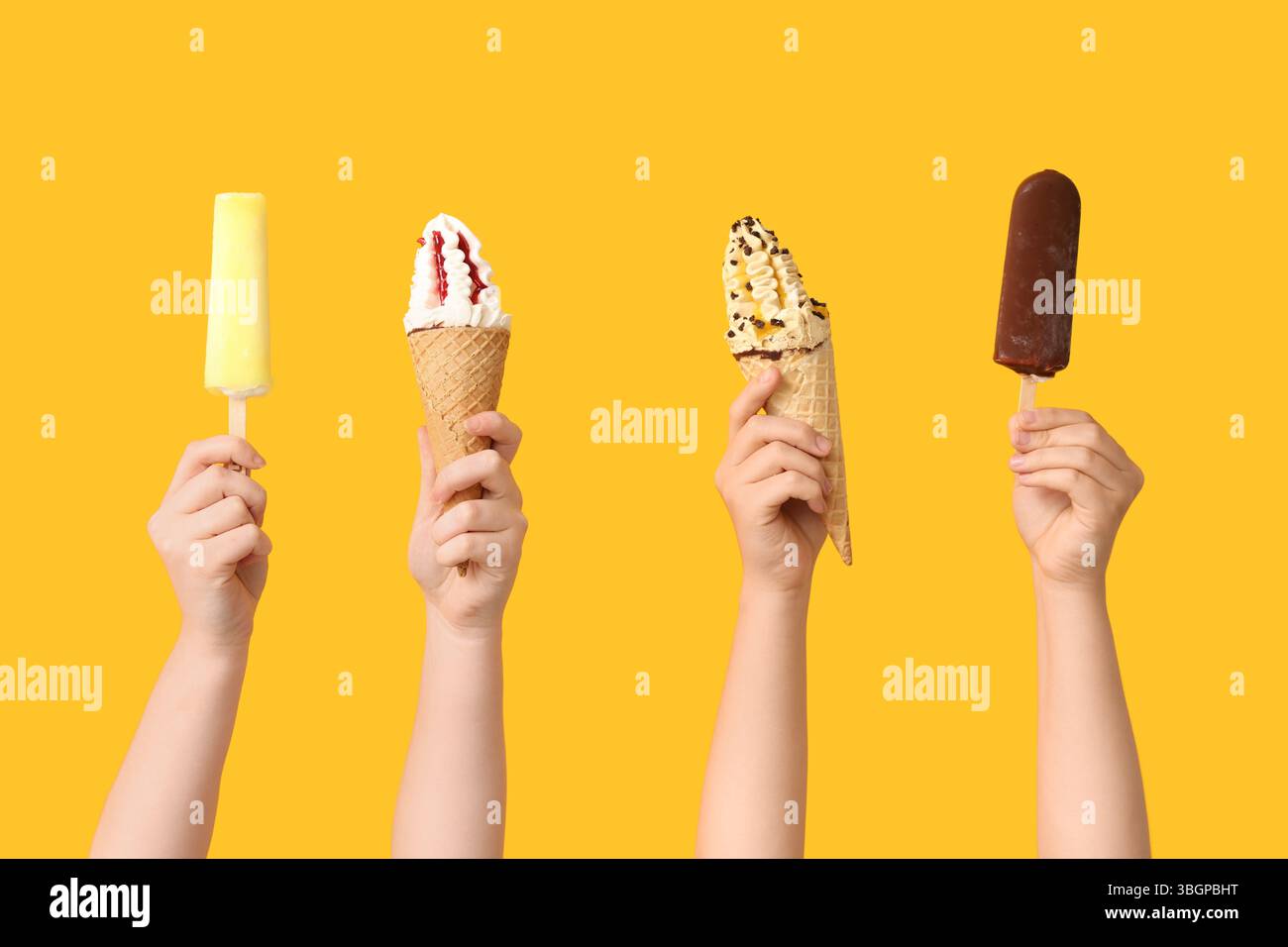 Mains féminines avec différentes glaces sucrées sur fond jaune Banque D'Images