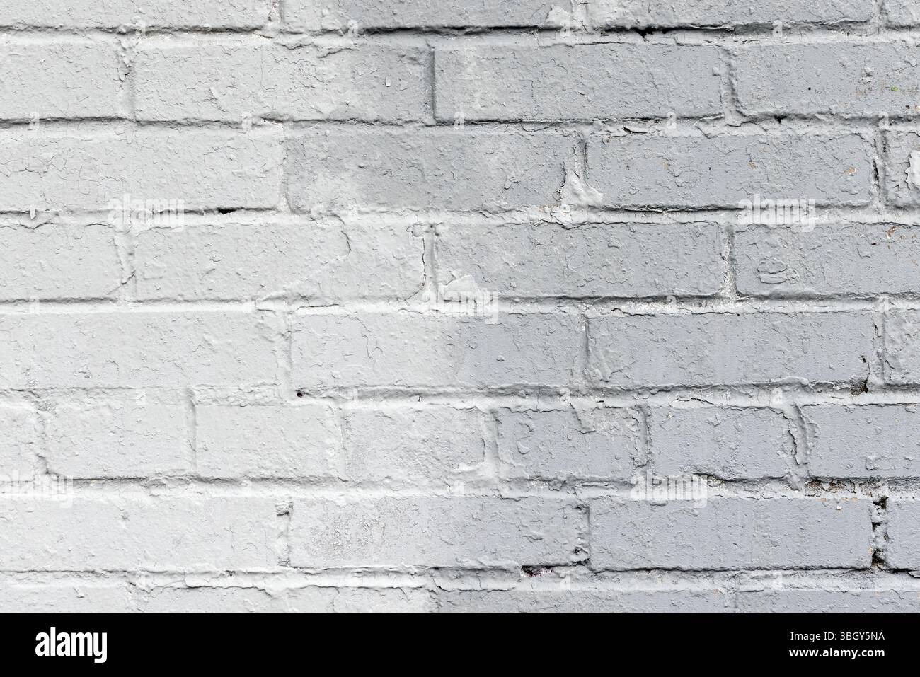 Mur de briques peintes en gris avec une texture de surface rugueuse. Photo de fond abstraite Banque D'Images