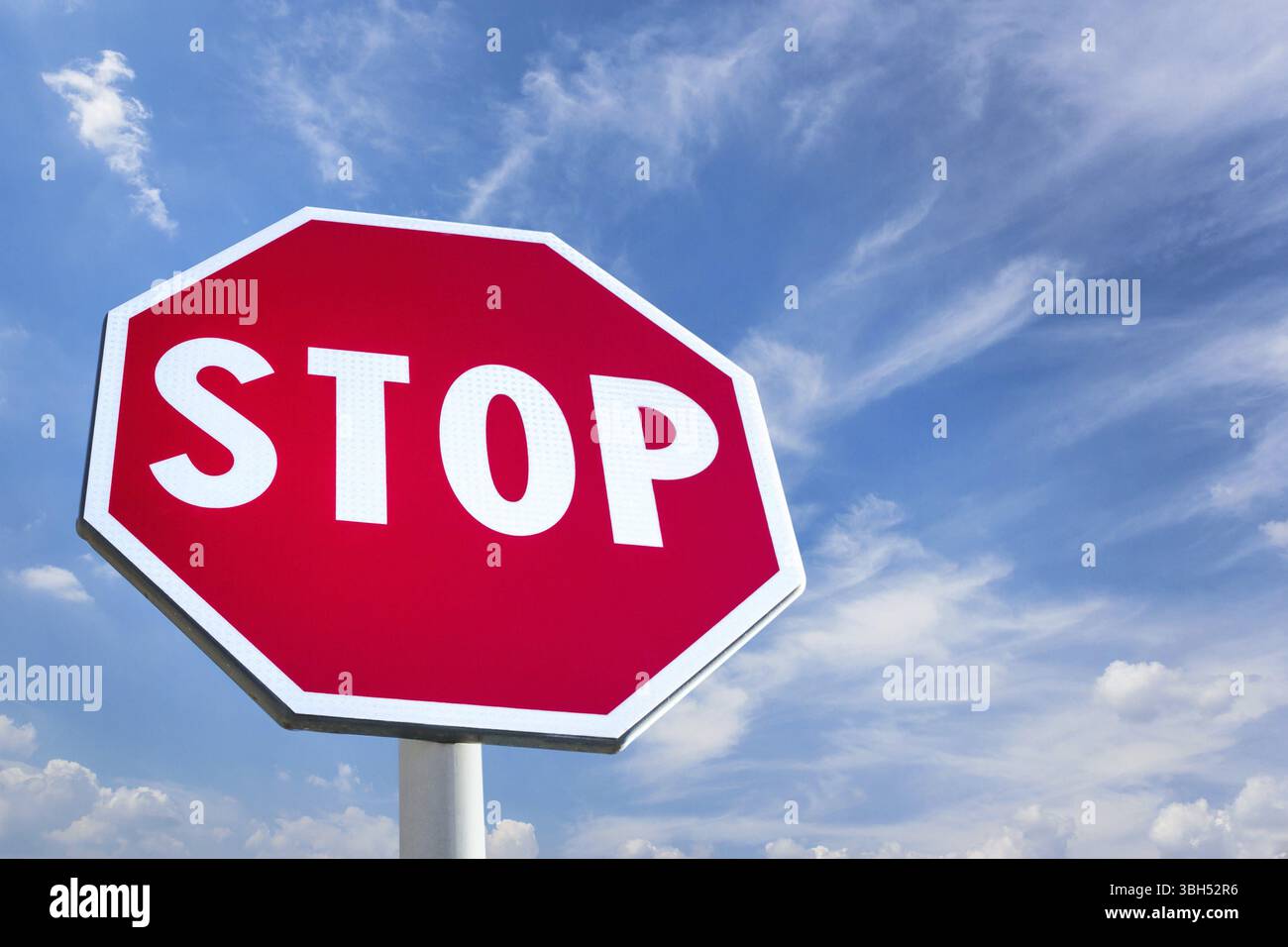 Panneau d'arrêt contre blue cloudy sky Banque D'Images