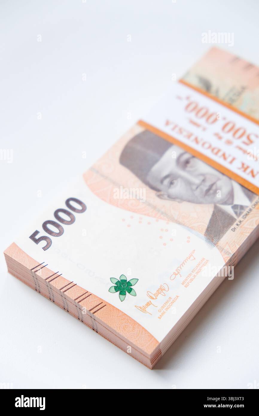 Pekanbaru, Indonésie - 21 mars 2025 : une pile de billets de banque rupiah indonésiens RP 5,000 isolés sur fond blanc pour THR sur Eid al-Fitr ou Lebaran Banque D'Images