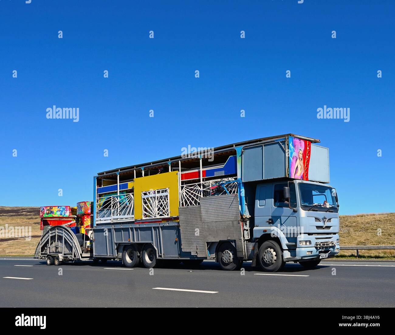 Fairground Ride transport HGV, voyageant à grande vitesse sur l'autoroute M6 Southbound Carriageway, Shap, Cumbria, Angleterre, Royaume-Uni, Europe. Banque D'Images