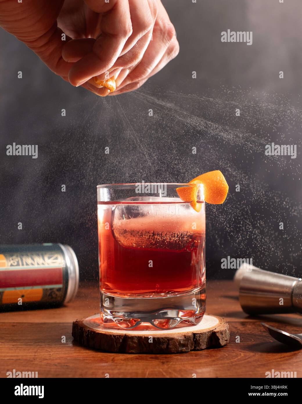 vaporisez les écorces d'orange sur un cocktail sur un comptoir Banque D'Images