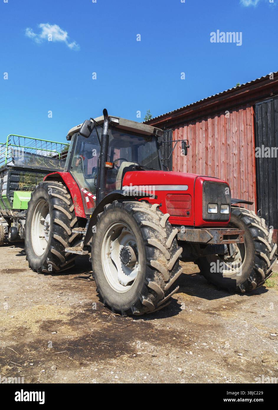 Tracteur avec remorque pour foin à la ferme Banque D'Images