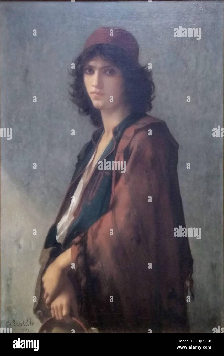 La peinture de Charles Landelle, 'Young Serbian Gypsy Woman', de 1872, est une huile sur toile représentant une jeune femme en tenue gitane traditionnelle. La peinture capture le regard expressif du sujet et ses vêtements détaillés, reflétant le style romantique de l'époque avec un accent sur l'identité culturelle et ethnique. Banque D'Images