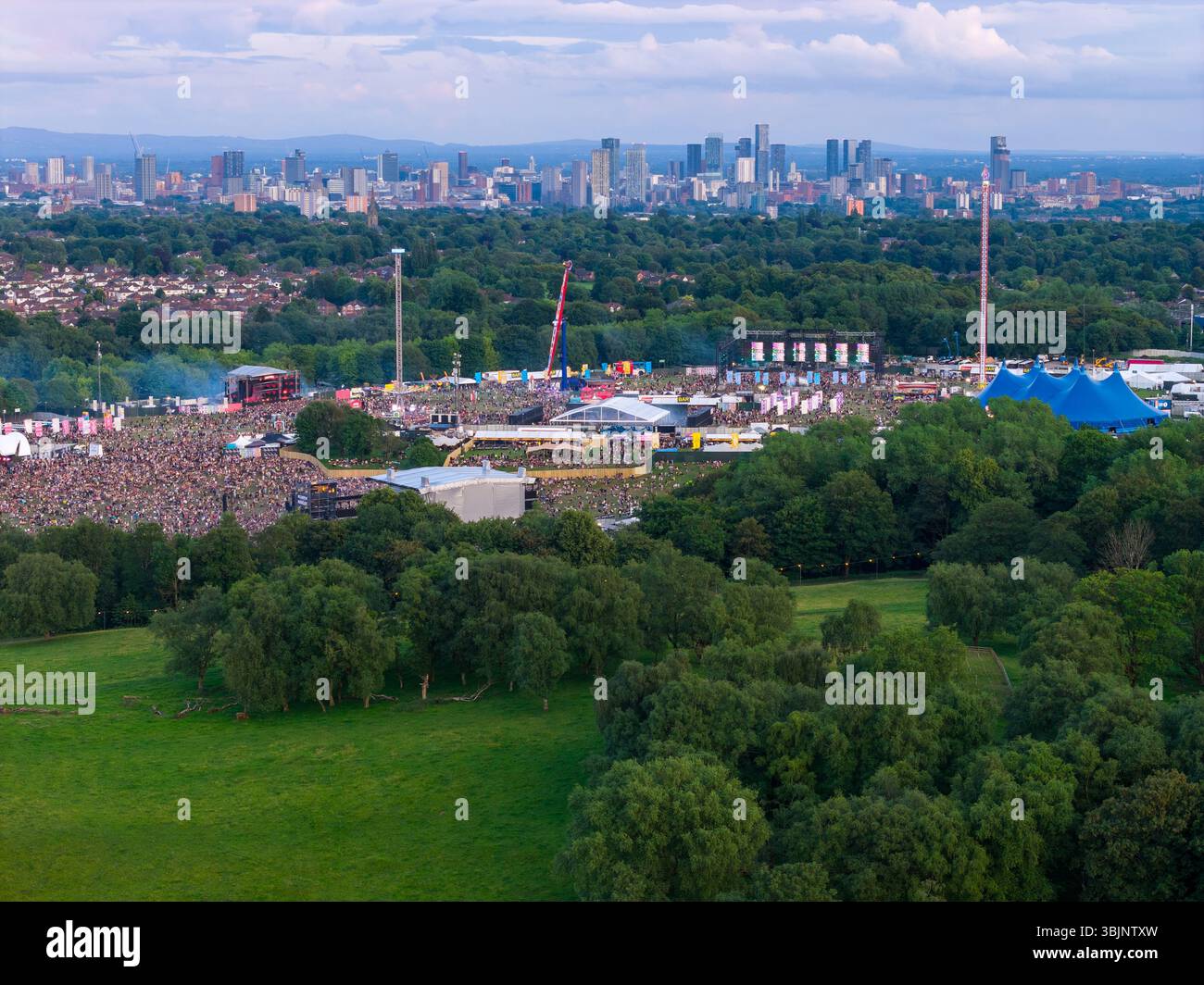 Image aérienne de Heaton Park dans le Grand Manchester avec Parklife Outdoor Music Festival avec Manchester City skyline en arrière-plan. Banque D'Images