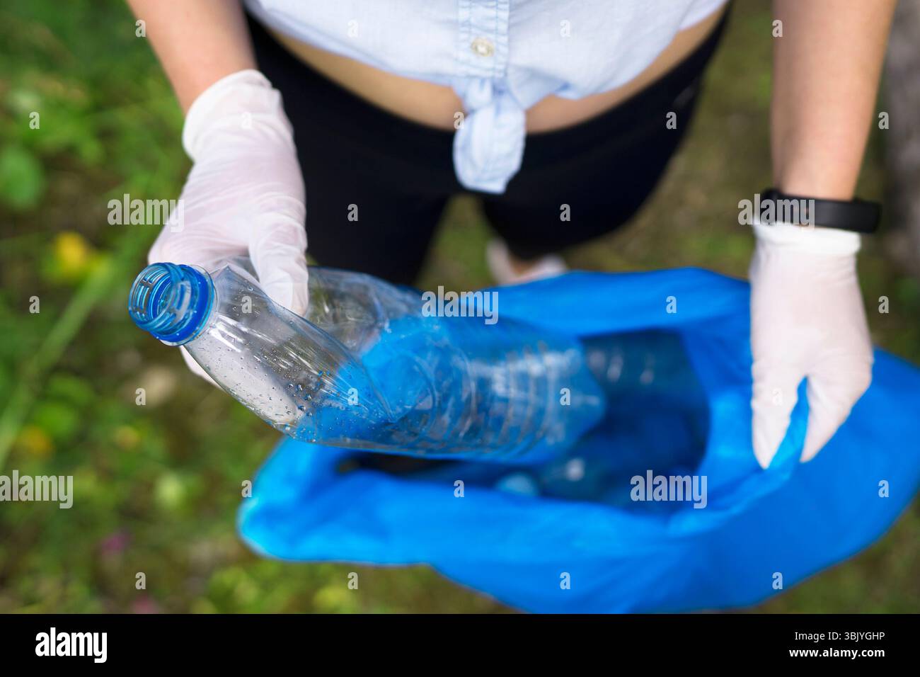 Faire du bénévolat pour recueillir des bouteilles dans la forêt. Concept de pollution de l'environnement. Banque D'Images