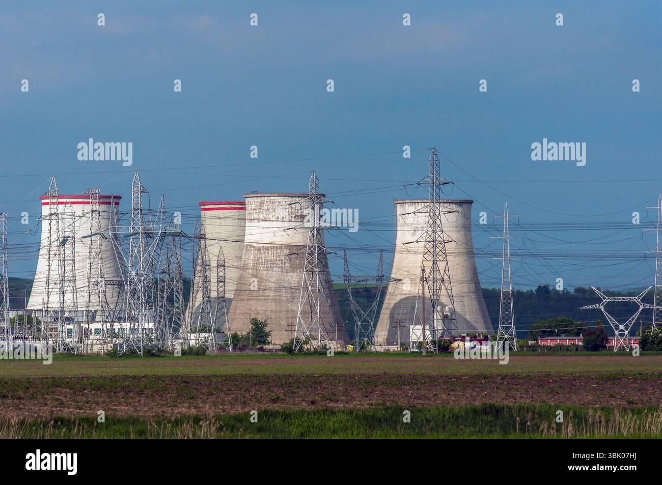 Centrale nucléaire avec pylônes électriques et ciel bleu Banque D'Images