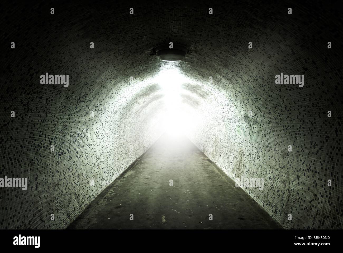 La lumière au bout du tunnel avec un mur carrelé Banque D'Images La lumière au bout du tunnel avec un mur carrelé Banque D'Images
