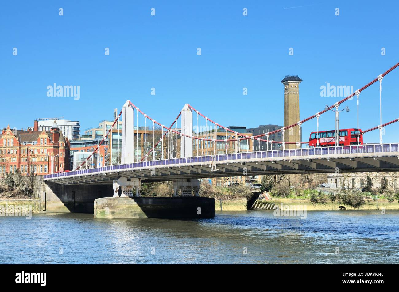 Vue du pont de Chelsea avec un bus rouge à impériale traversant la Tamise de Battersea à Chelsea sur la rive nord, Londres, Angleterre, Royaume-Uni. Ponts Banque D'Images Vue du pont de Chelsea avec un bus rouge à impériale traversant la Tamise de Battersea à Chelsea sur la rive nord, Londres, Angleterre, Royaume-Uni. Ponts Banque D'Images