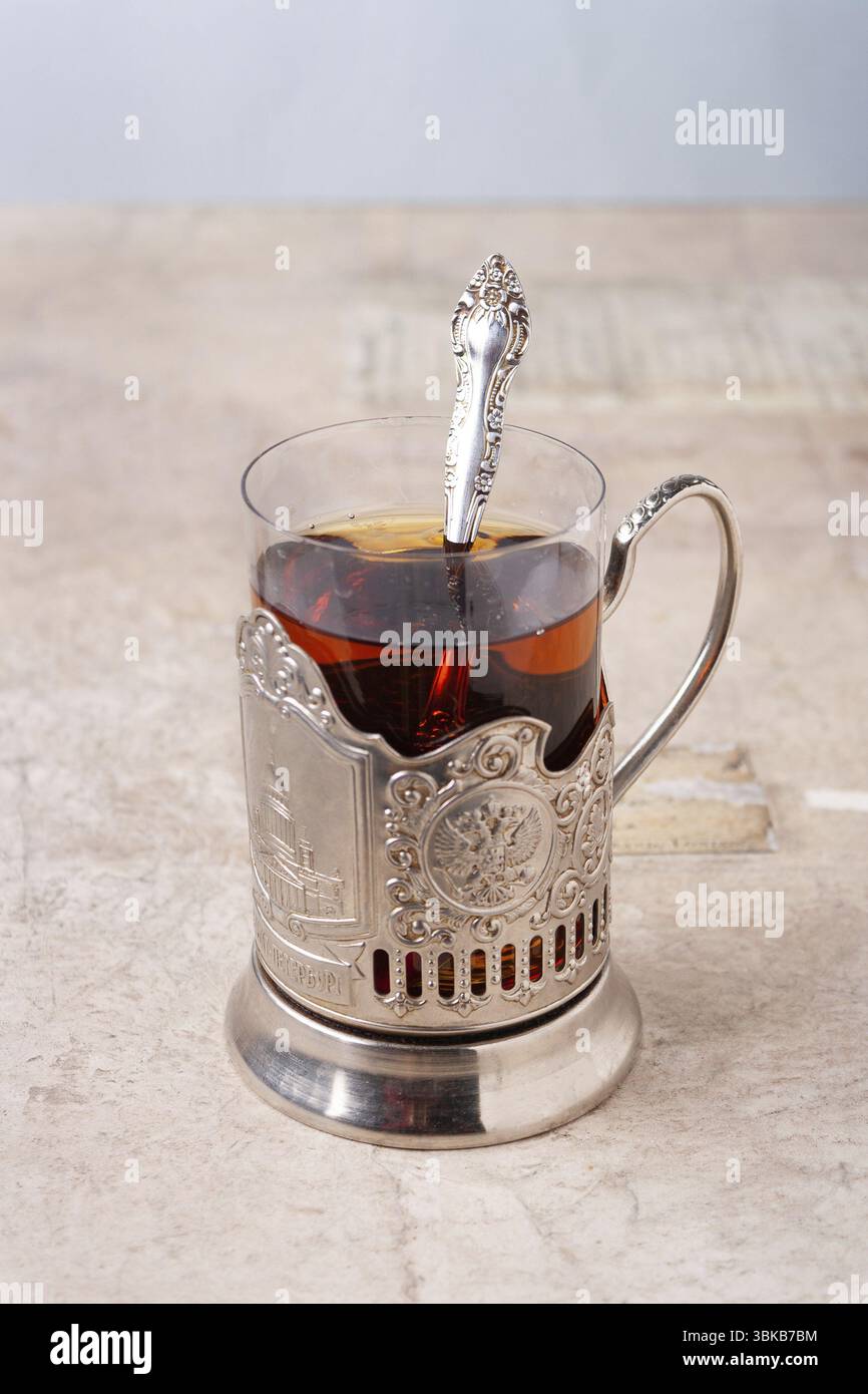 Un verre de thé dans un porte-gobelet en métal sur la table Banque D'Images