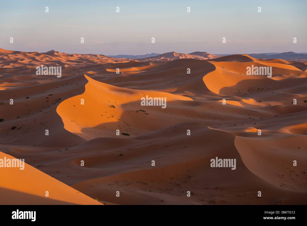 Merzouga, Maroc : vue panoramique du coucher de soleil sur la Merzouga depuis les dunes de sable de l'Erg Chebbi dans le désert du Sahara au Maroc Banque D'Images