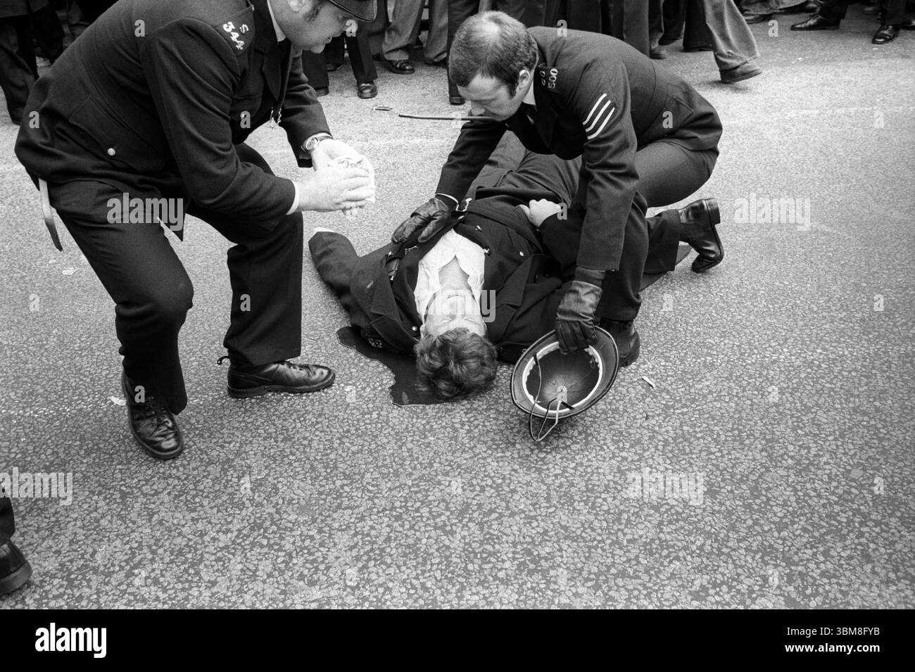 Grève de Grunwick et conflit du travail. P C Trevor Wilson est dans une piscine de son propre sang lors de violents affrontements entre manifestants et policiers à l'extérieur de l'usine de traitement de films de Grunwick. Willesden, Londres, Angleterre 1977 1970s UK HOMER SYKES Banque D'Images