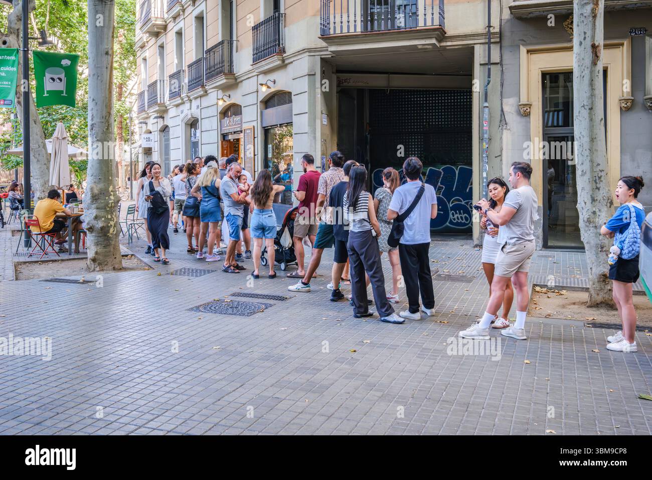 Barcelone - Espagne - 06-24-2025 : longue file d'attente de personnes devant le populaire Ice Cream Shop dans une rue animée de Barcelone. Tendance dessert viral, urb Banque D'Images