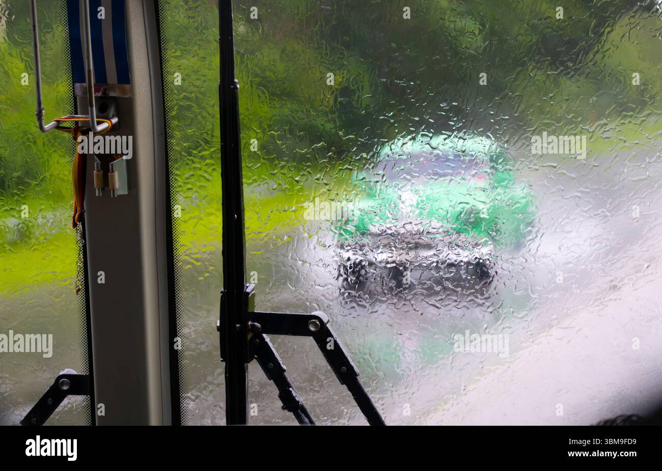 Pluie lourde, voiture américaine verte à Cuba, Caraïbes visible derrière pare-brise mouillé avec essuie-glace Banque D'Images Pluie lourde, voiture américaine verte à Cuba, Caraïbes visible derrière pare-brise mouillé avec essuie-glace Banque D'Images