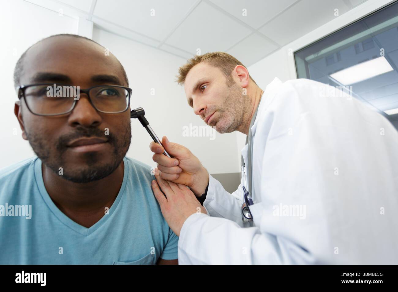 médecin vérifiant l'oreille du patient pendant l'examen médical Banque D'Images