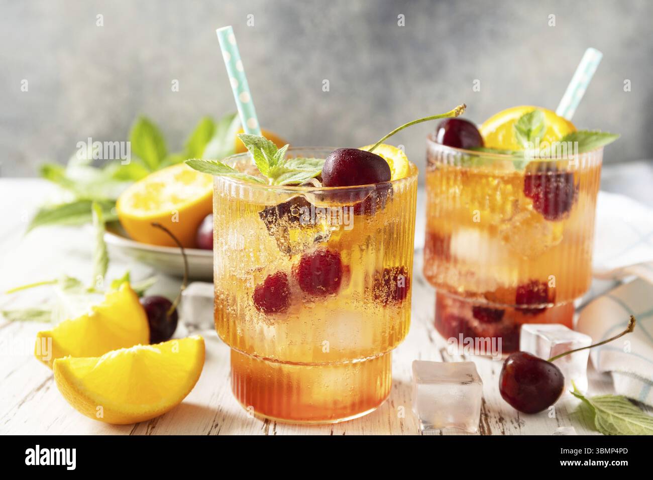 Boisson rafraîchissante glacée limonade de cola cerise orange ou cocktail mojito dans un verre sur une table en bois. Boisson fraîche d'été Banque D'Images