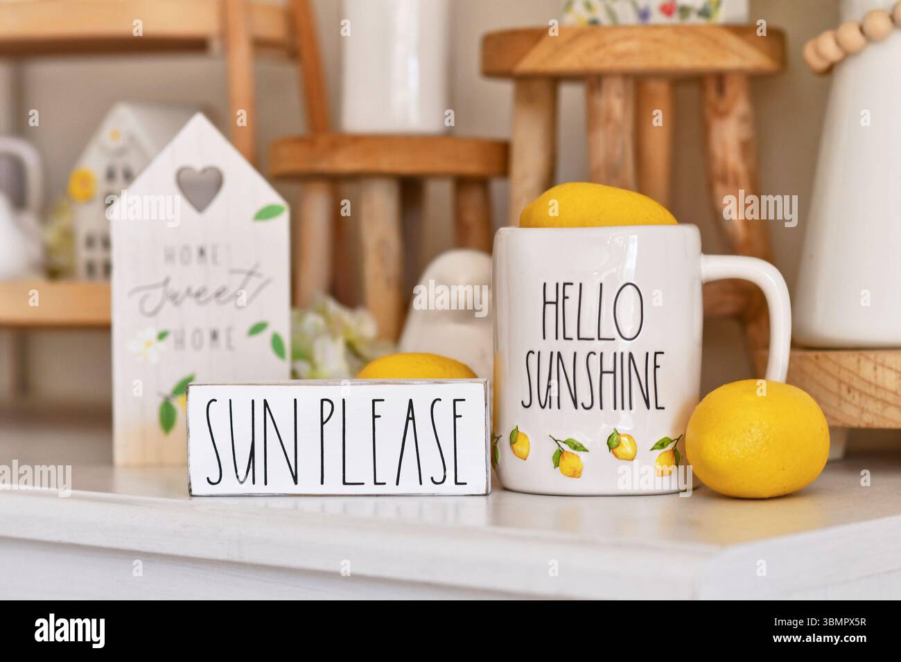 Allemagne - juin 2025 : décoration de maison d'été saisonnière avec mug avec texte « Hello Sunshine », panneau indiquant « Sun Please » et citrons Banque D'Images