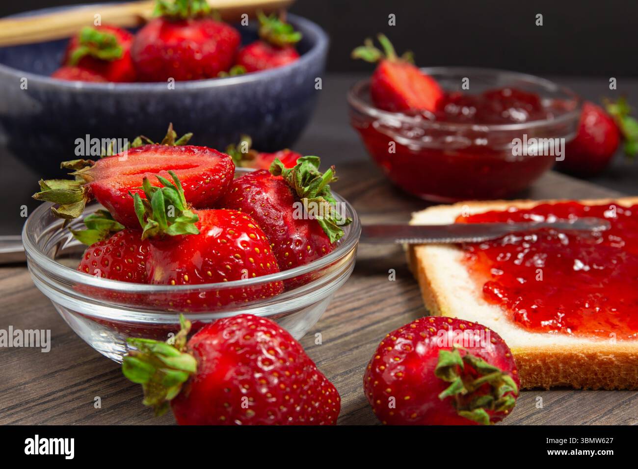 Bols de fraises mûres et pain grillé avec tartinade aux fraises, idée de petit déjeuner et conserves de saison Banque D'Images