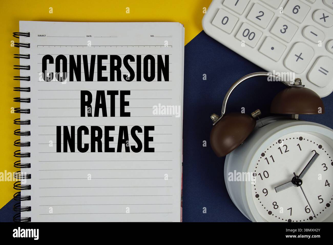 Taux de conversion augmenter texte écrit sur le bloc-notes avec calculatrice et réveil sur fond bleu marine Banque D'Images