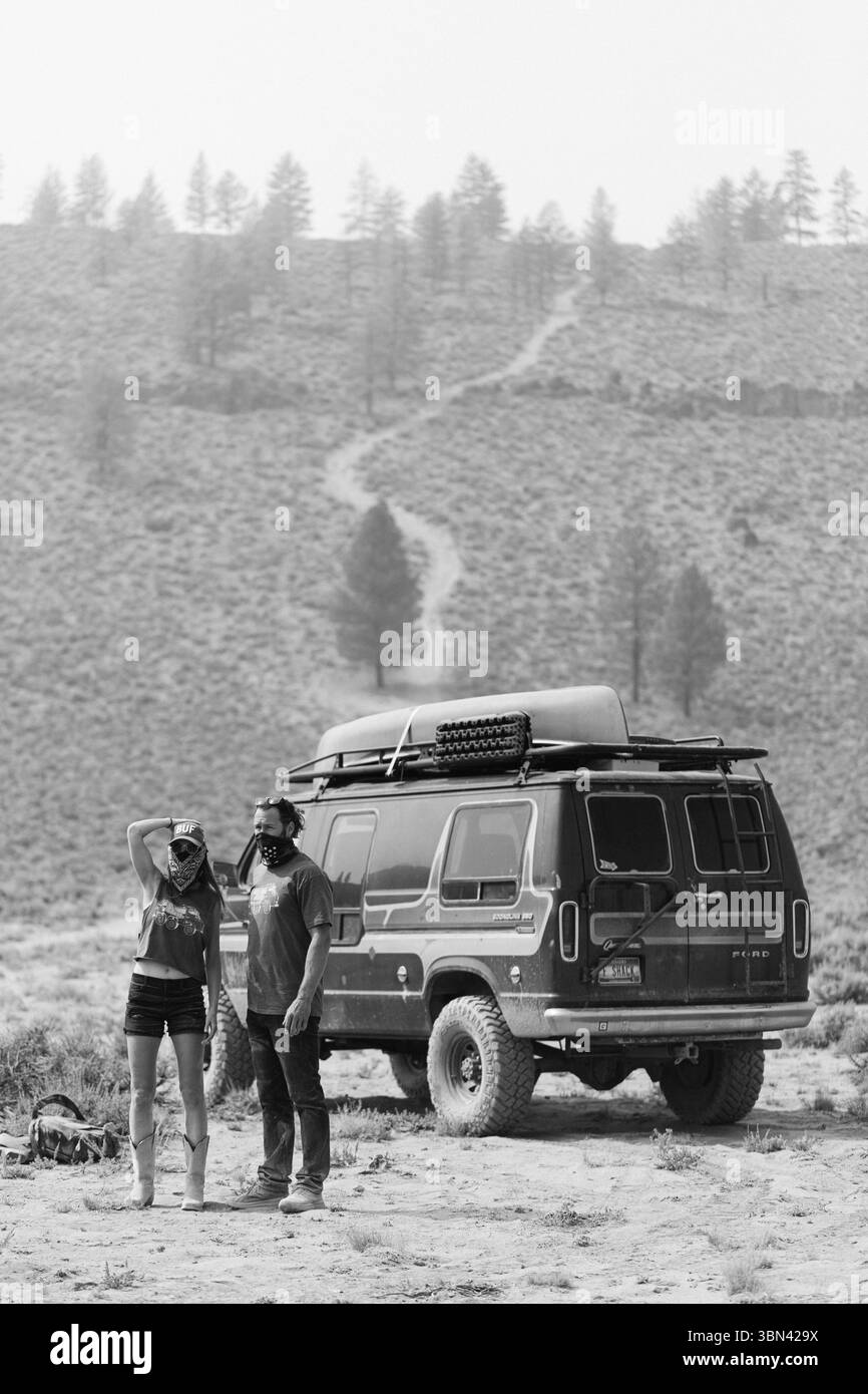 Couple profitant d'une vue panoramique pendant le voyage en voiture avec van dans le désert Banque D'Images