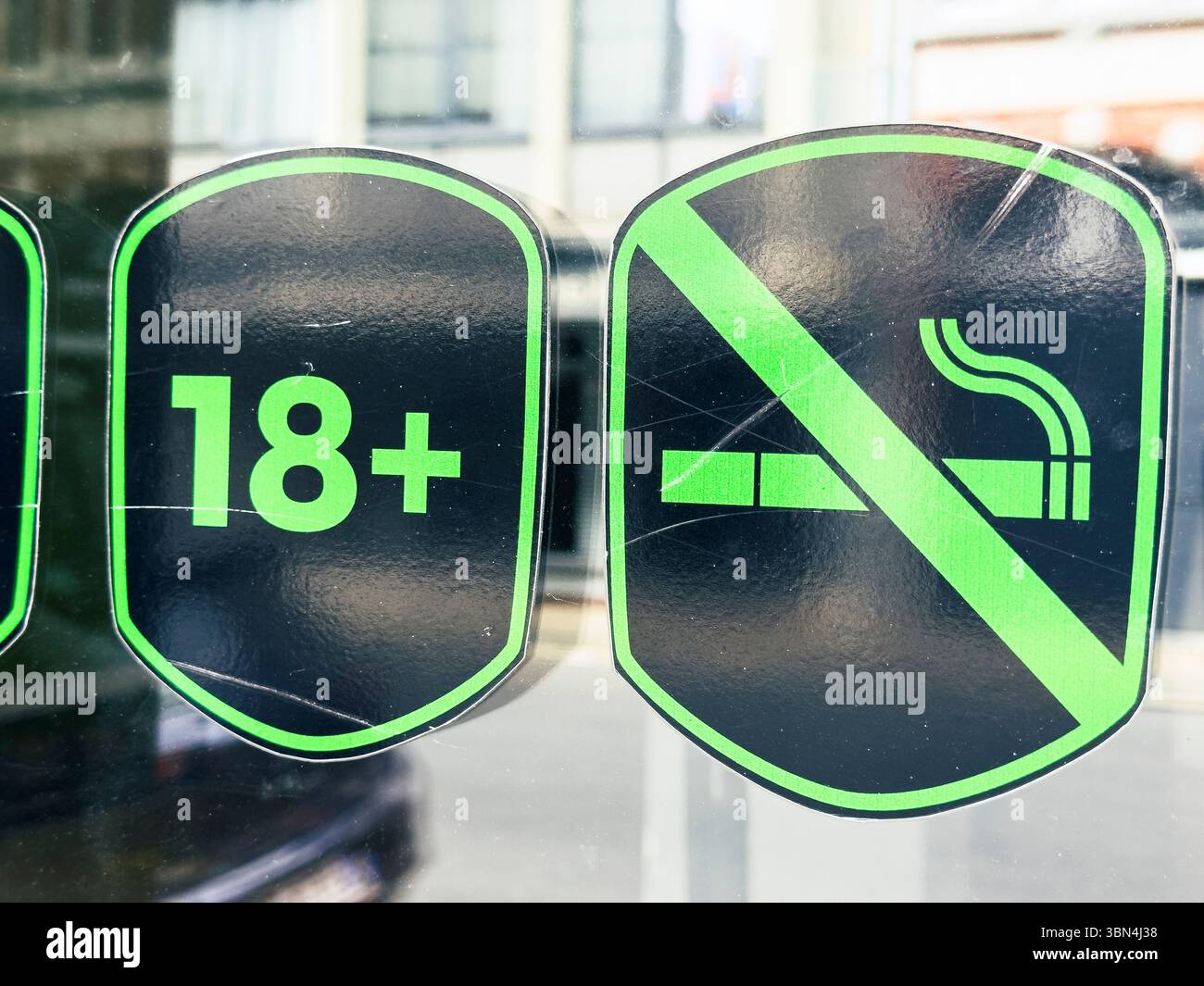 Entrée d'un magasin avec deux autocollants. Non fumeur et moins de 18 ans interdit. Banque D'Images