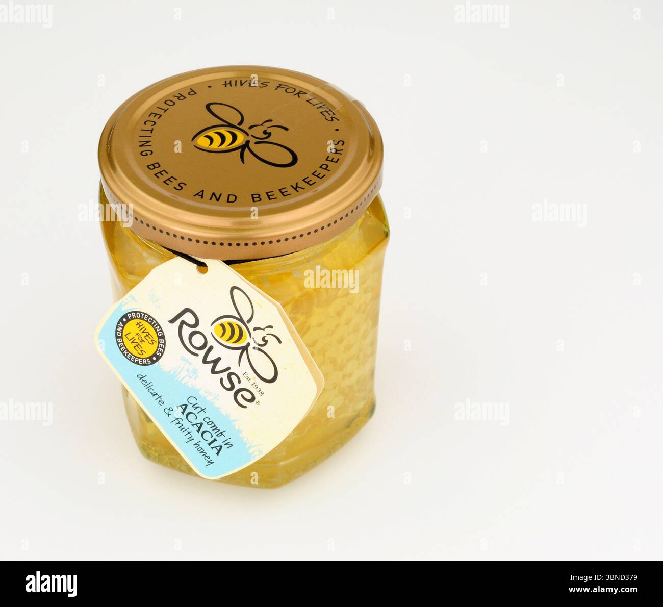 Rowse coupé nid d'abeilles dans du miel d'acacia dans un pot en verre de 340g. Banque D'Images