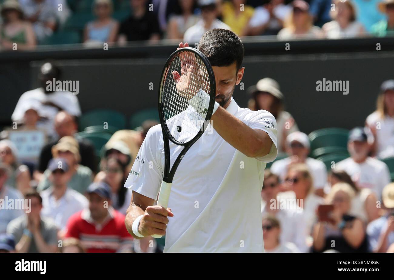 Novak Djokovic of Serbia reacts as he plays against Daniel Evans of the United Kingdom during the men's singles second-round match on day four of the Wimbledon Championships at the All England Lawn Tennis and Croquet Club in London, on Thursday, July 3, 2025. ( The Yomiuri Shimbun via AP Images ) Banque D'Images