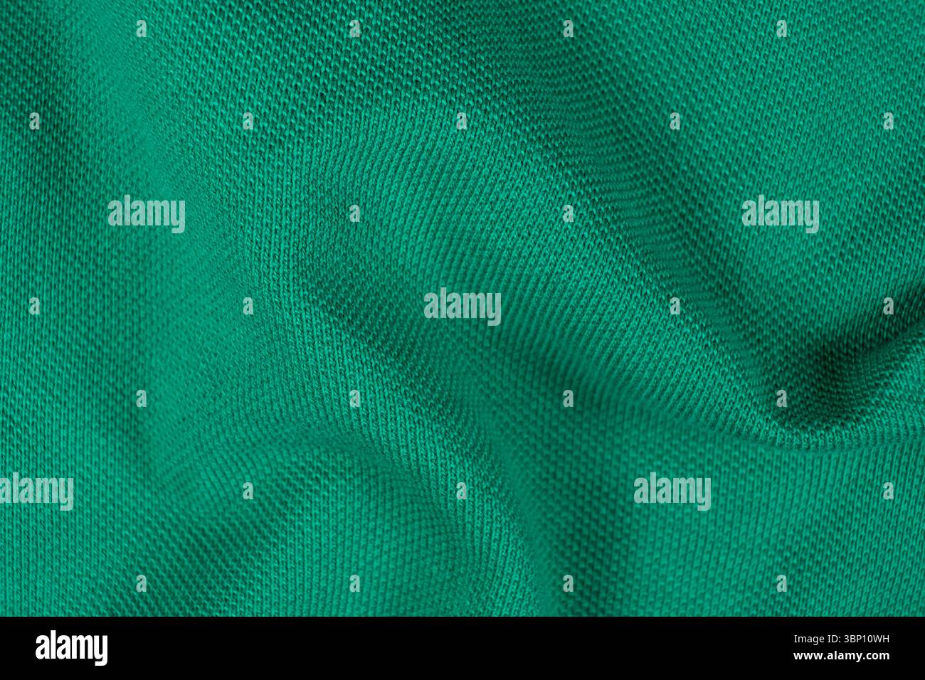 Gros plan de la surface textile en coton émeraude vert abstrait vue de dessus. Banque D'Images