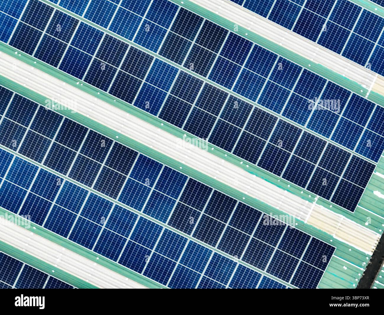Vue aérienne d'un toit d'entrepôt avec panneaux solaires générant de l'électricité verte. Le passage aux énergies renouvelables, aux solutions d'énergie propre, Banque D'Images