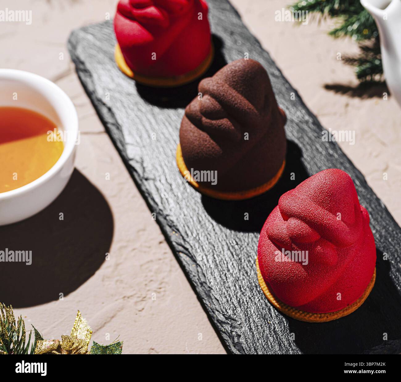 Nourriture, trois desserts au design unique reposent sur un plateau en ardoise noire. Les friandises présentent des couleurs éclatantes et ressemblent à des personnages ludiques, complétées par un Banque D'Images