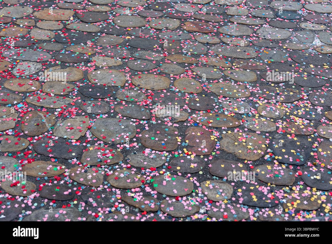 Confettis colorés (morceaux de papier) recouvrant le trottoir jeté par les acclamateurs du carnaval pendant le carnaval de Bâle, en Suisse. Banque D'Images