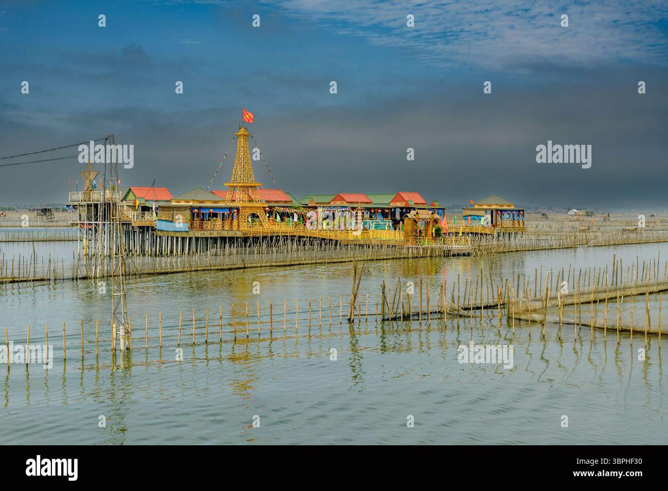 Restaurant maison sur pilotis sur un lagon à Thuy Dien, Hue, Vietnam. Le restaurant est construit sur pilotis au-dessus de l'eau, entouré de poteaux de bambou utilisés pour Banque D'Images