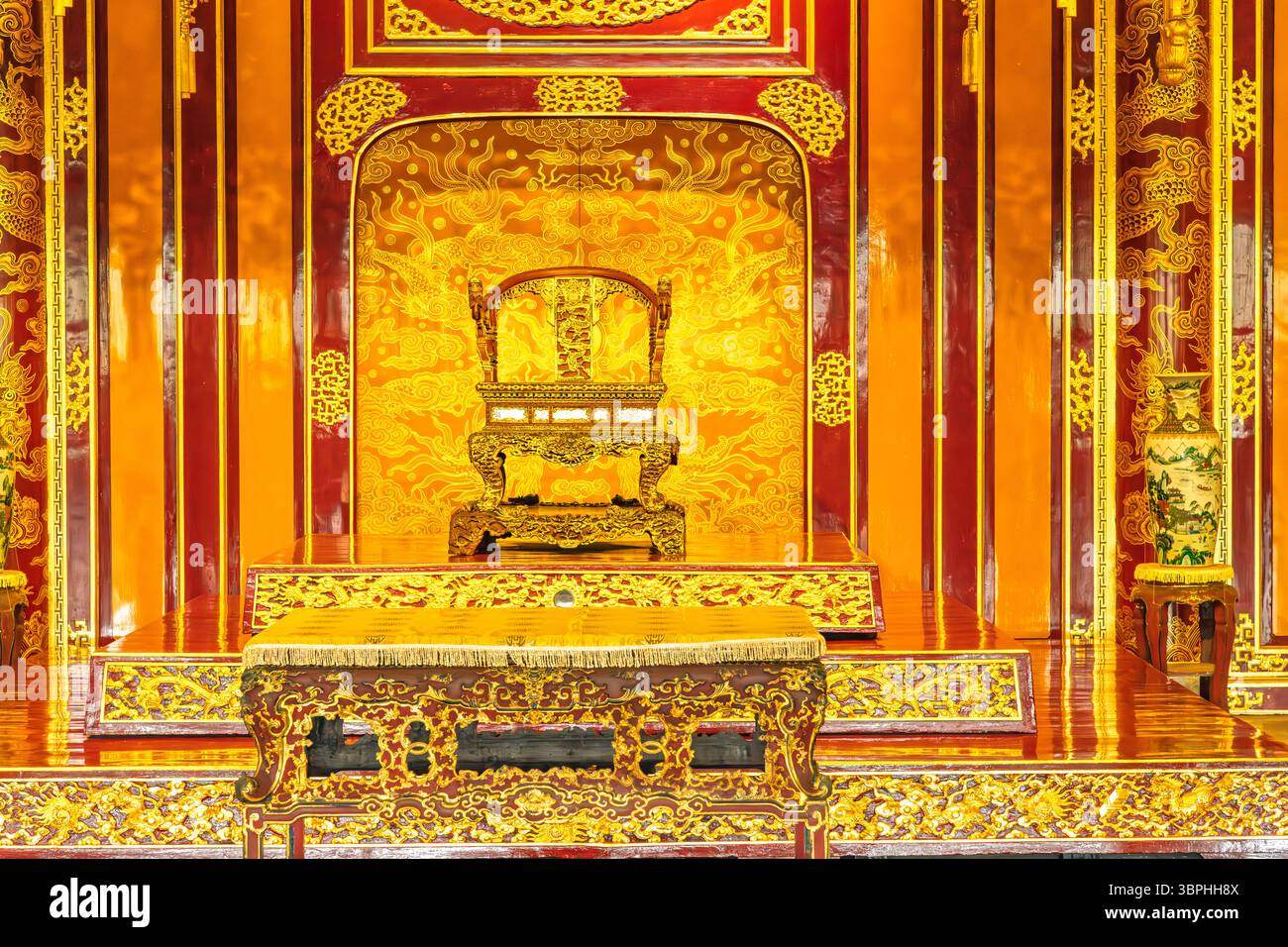 Trône en bois orné du roi et table dans un palais vietnamien traditionnel intérieur.ville impériale, Hué, Vietnam, Asie du Sud-est Banque D'Images