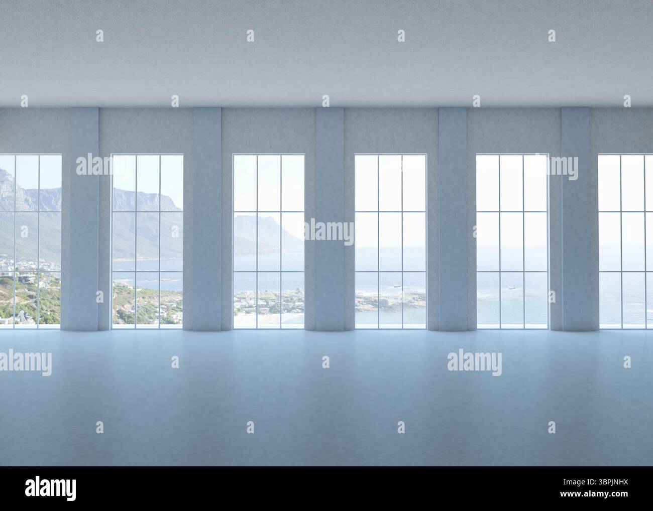 Le hall design plat est doté d'un sol en béton, de colonnes encadrant des fenêtres pleine hauteur donnant sur la mer Banque D'Images