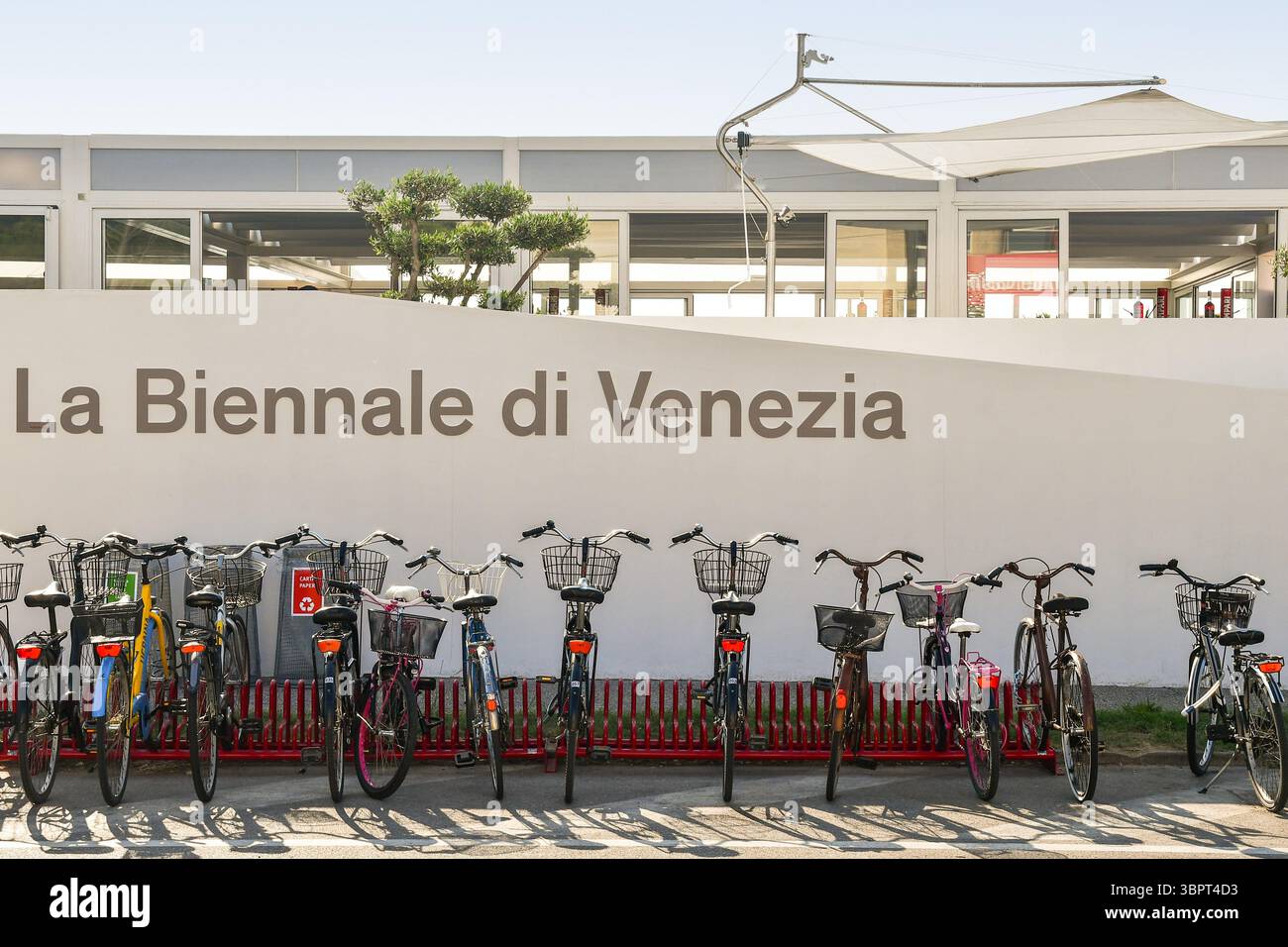 Vélos garés devant un mur avec le panneau 'la Biennale di Venezia' (la Biennale de Venise), au 81ème Festival du film de Venise, Lido de Venise, Italie Banque D'Images