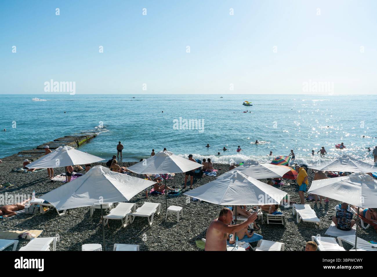 Sotchi, Russie - 05 juillet 2022 : plage de la ville au bord de la mer avec chaises longues et parasols. Banque D'Images